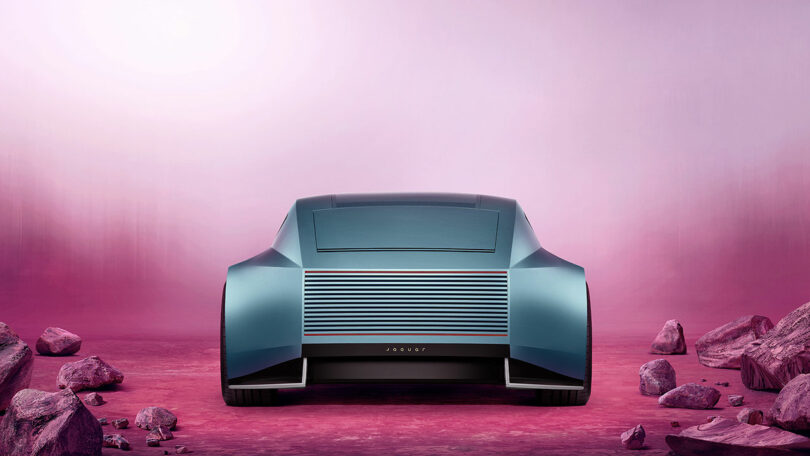 Futuristic car with smooth curves on a pink rocky landscape, viewed from the rear.