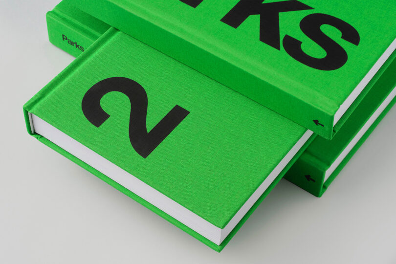 A stack of bright green hardcover books with bold black lettering.