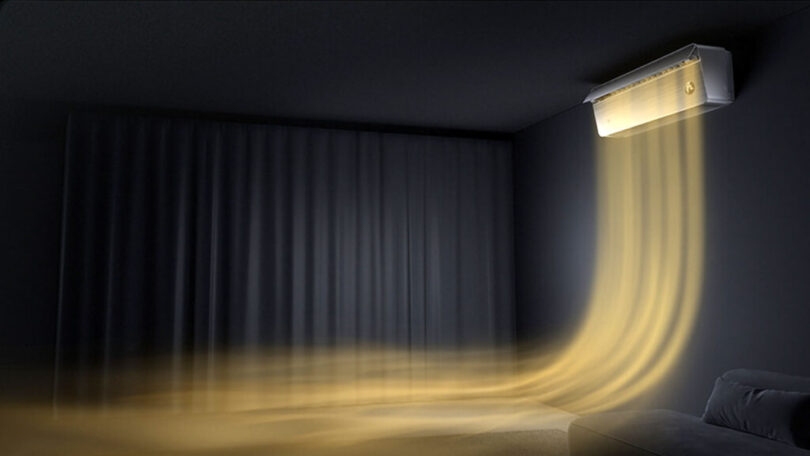 Air conditioner on a dark wall emitting a golden glow, with light streams flowing downward into a dimly lit room.