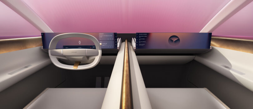 Futuristic car interior with a minimalist design, featuring two digital displays and a streamlined steering wheel under a tinted pink windshield.