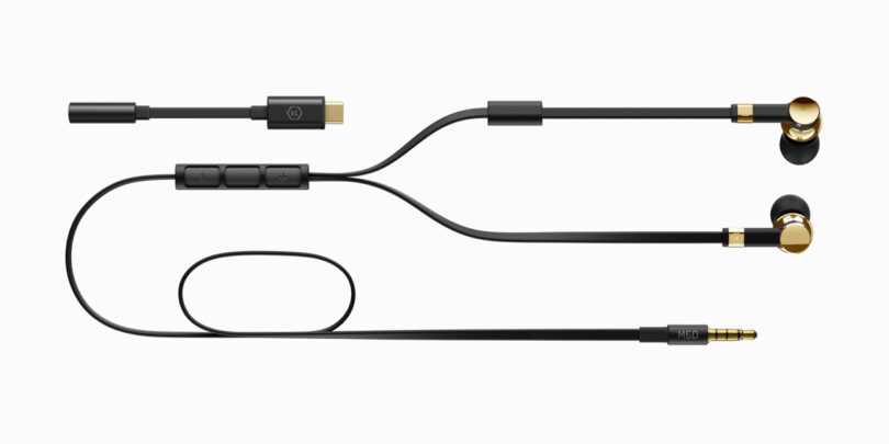 Black and gold in-ear headphones with a built-in remote and a 3.5mm audio jack cable, shown in an extended layout.