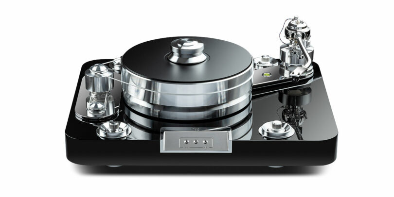 The Signature 12.2 high-end, black and chrome turntable boasts a glossy finish with intricate design details, featuring a precision-engineered tonearm and sleek control knobs.