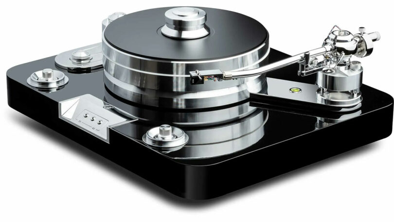 The Signature 12.2 is a high-end turntable featuring a polished black base, silver tonearm, and large central platter, perfectly crafted for playing vinyl records.