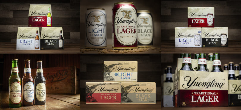 A display of Yuengling beer varieties including cans and bottles of Lager, Light Lager, and Black & Tan, arranged on wooden surfaces