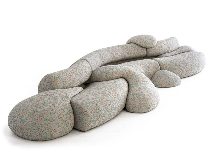 A modular, abstract-shaped sofa with a brownish-gray speckled pattern.