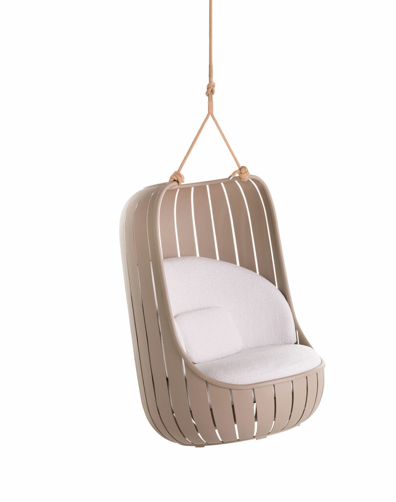 Beige hanging chair with slatted design and white cushion, supported by two ropes.