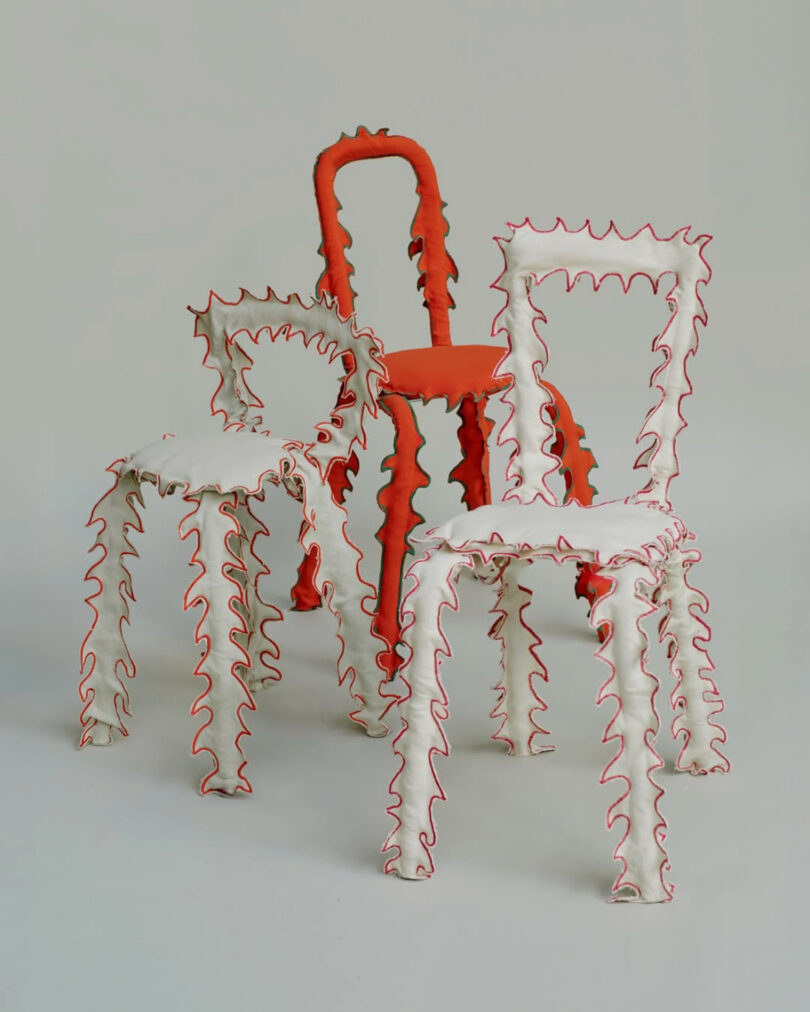 Three artistic chairs with textured, wavy outlines in orange and white colors.