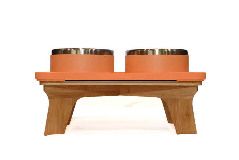 Wooden pet feeder with two stainless steel bowls on an elevated stand.