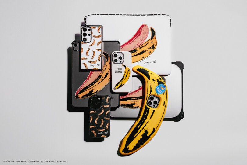 Assorted devices with cases featuring banana art designs, including a large banana figure resembling a phone case, set against a plain backdrop.