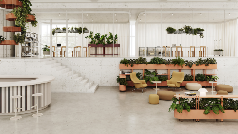 Modern open-plan office with plants, tiered seating, and white walls. It features green chairs, circular tables, a bar area, and a staircase. Light streams through large windows