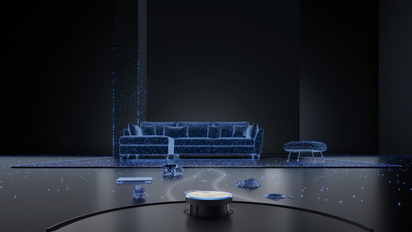 A holographic projection of a modern living room with a sofa and ottoman. A robotic vacuum is in the foreground, with digital particles scattered around.