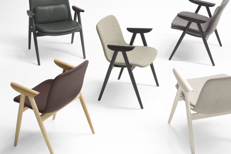 A curated collection of modern Keilhauer chairs, featuring diverse wood and fabric finishes, elegantly arranged on a pristine white background.