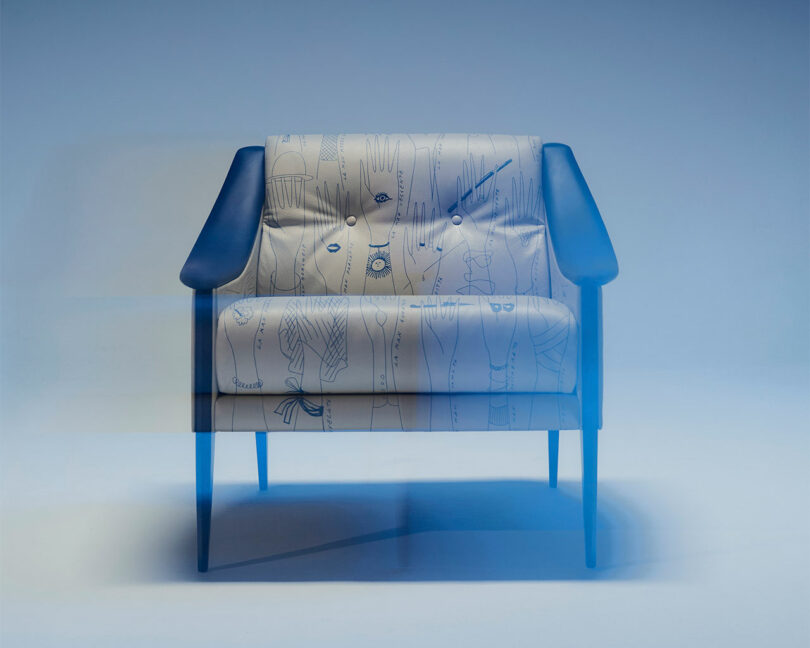 Modern armchair with dark armrests and legs, featuring light fabric adorned with abstract line patterns reminiscent of Gio Ponti's aesthetic. The image has a blue tint.