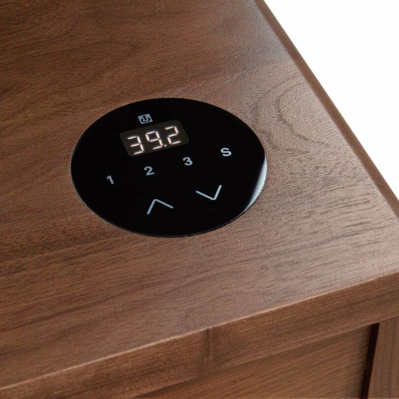 A wooden surface with a digital control panel displaying "39.2" and buttons labeled 1, 2, 3, and S, along with up and down arrows.