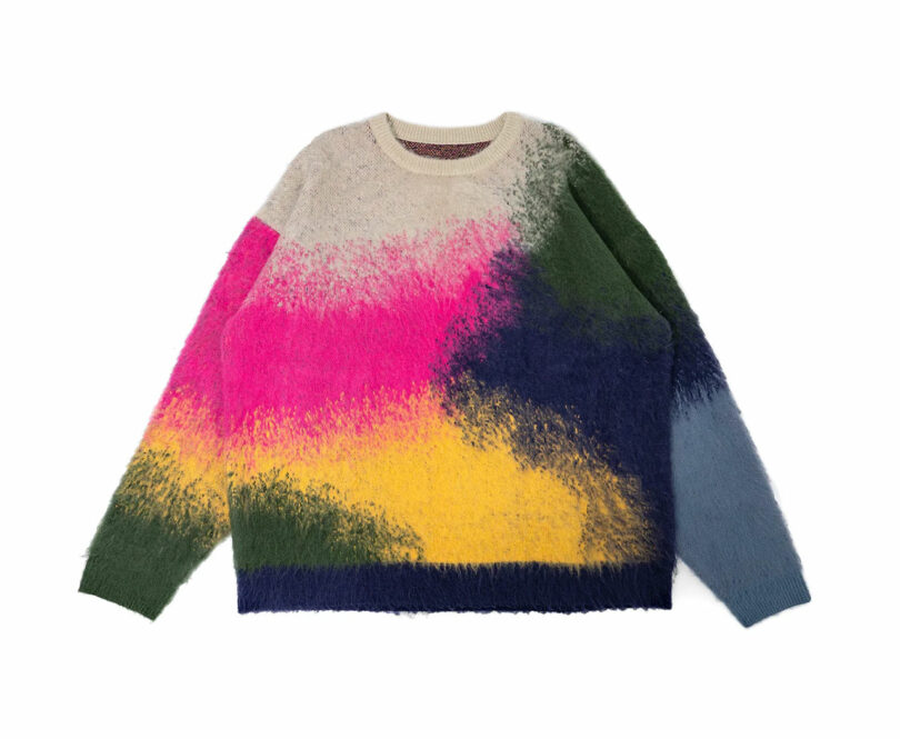 Fuzzy sweater with abstract color blocks in pink, yellow, green, beige, and blue.