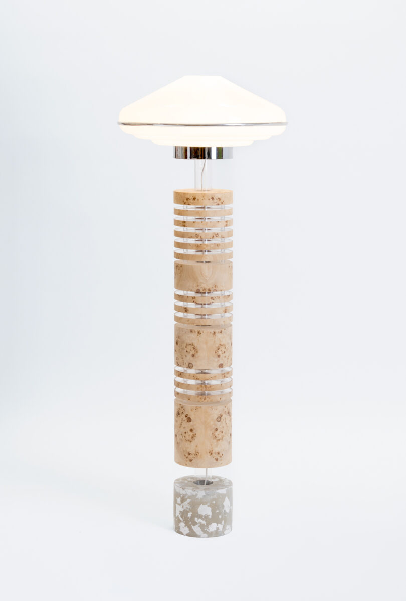 Modern floor lamp with a stacked cylindrical marble base and a white dome-shaped shade, set against a plain white background