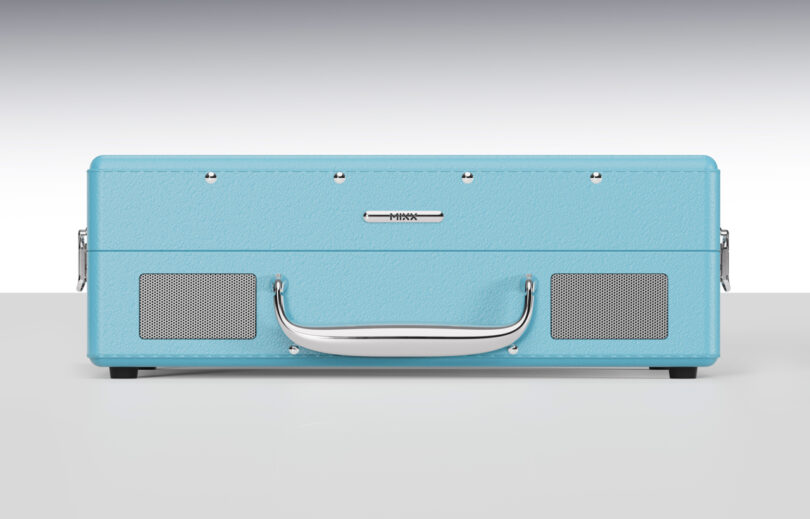 A closed blue turntable case with a chrome handle and two small speaker grills on the front.