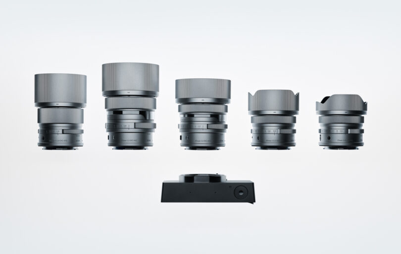 Five camera lenses of varying sizes are displayed in a row above a sleek Sigma BF rectangular camera body.