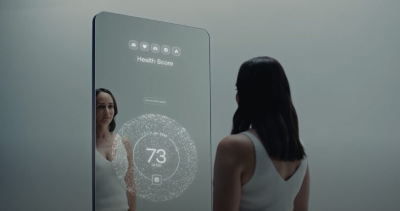 A woman stands in front of a large smart mirror displaying a health score of 73 out of 100.