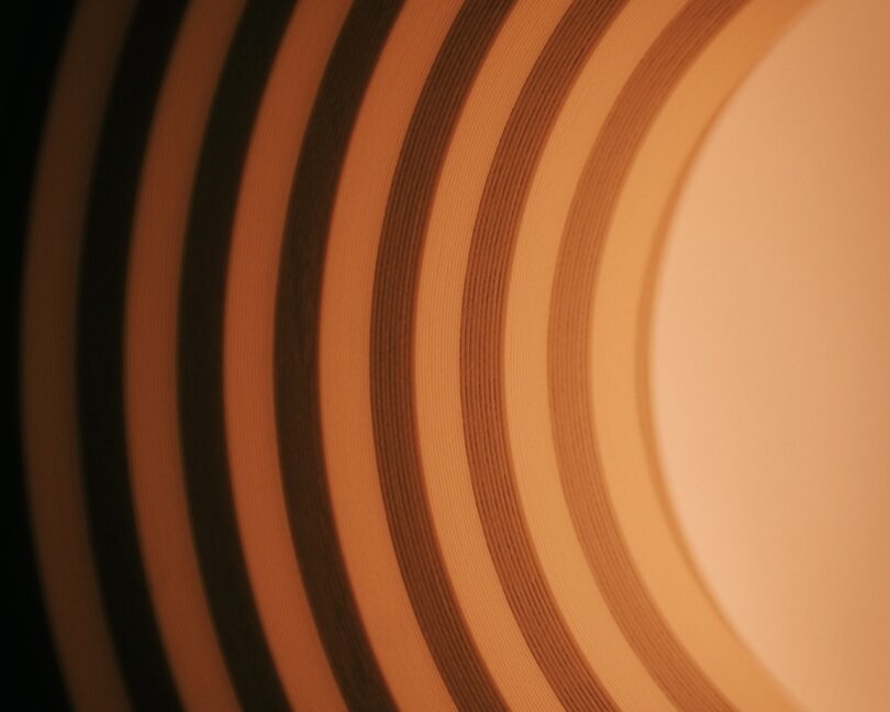 Abstract image of concentric brown and beige circles creating a layered, spiral pattern