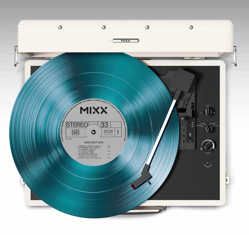 A teal vinyl record is spinning on a vintage-style turntable with a white case. The label reads "MIXX Stereo 33 Greatest Hits," blending classic aesthetics with modern Mixx quality, making it a perfect choice for audiophiles and music lovers alike.