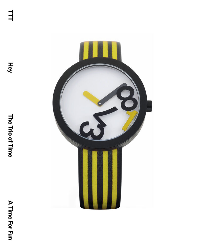 Stylish watch with large black numerals at odd angles on a white face. Black and yellow striped band. Text: "TTT Hey The Trio of Time A Time For Fun" on the sides.