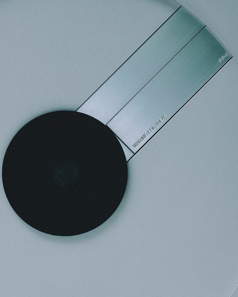 Close-up of the PP-1 metallic angle ruler featuring a sleek black circular knob against a gray background.