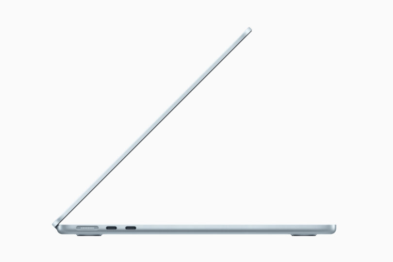 Side view of a slim, partially open laptop showing two USB-C ports and one audio jack on a sleek, minimalist design.