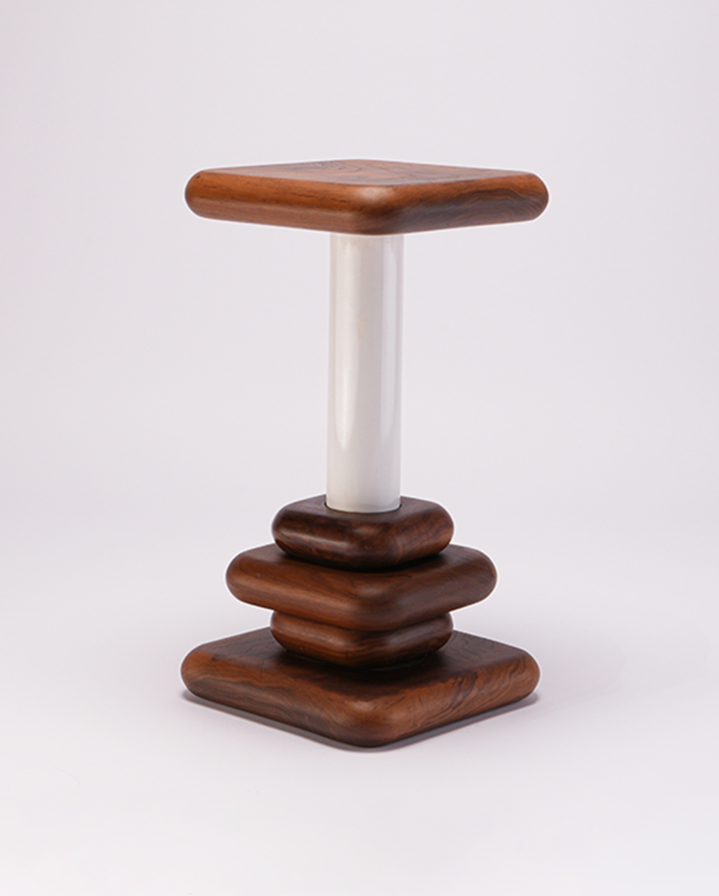 A wooden side table with a square base and top, featuring stacked wooden layers and a central white cylindrical support.