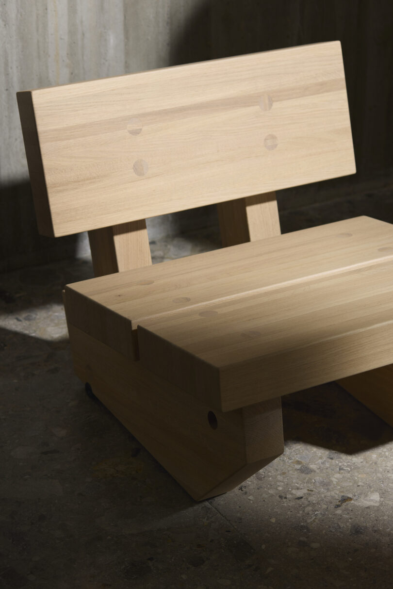 Minimalist wooden chair with a straight backrest and flat seat