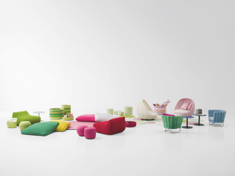 A collection of colorful, modern furniture and decor pieces, including chairs, tables, cushions, and baskets, displayed against a white background