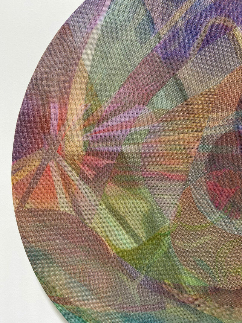 A close-up of a circular textile artwork by Katherine Duclos, featuring overlapping, multicolored lines and geometric patterns on a light background.