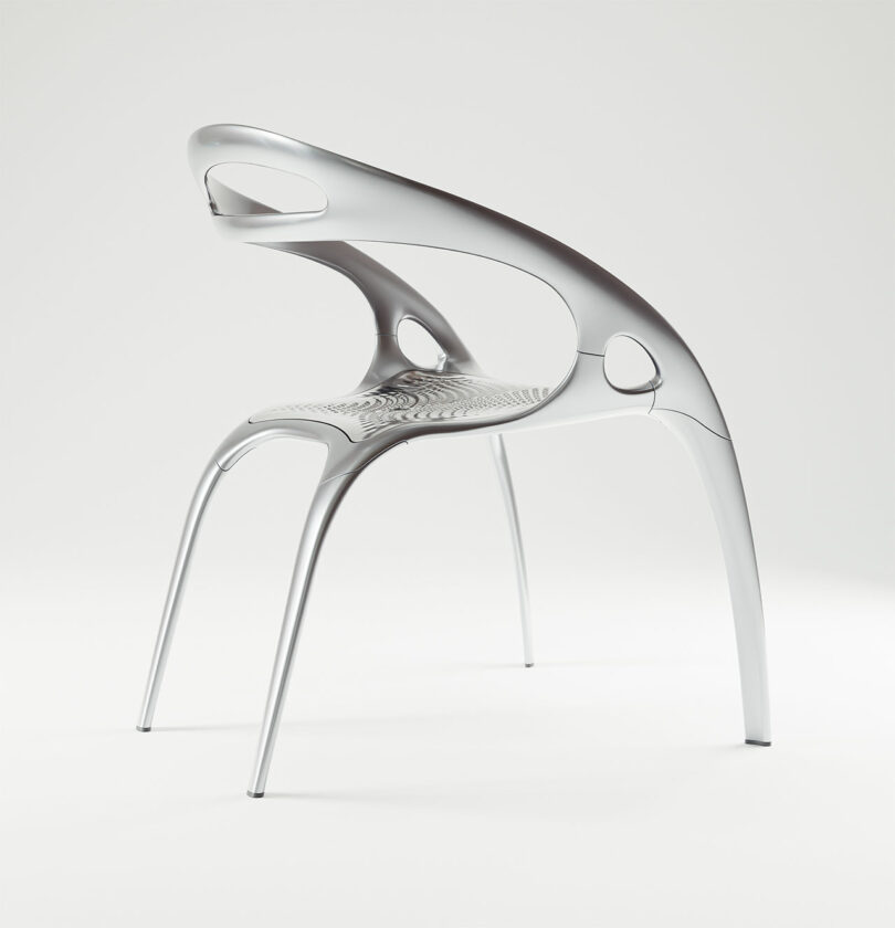 A modern, metallic PolarisGo chair with a sleek, curved design, open backrest, and cut-out details, displayed against a plain white background.