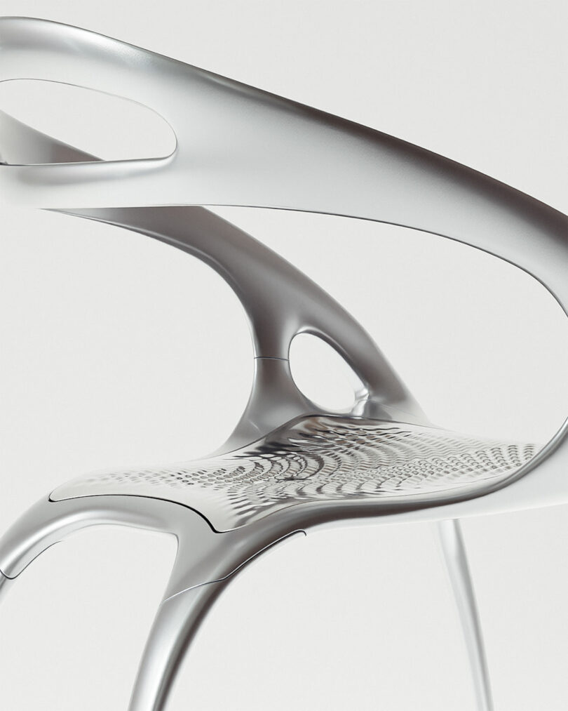 A modern, metallic PolarisGo chair with a curved, lightweight design and cut-out details, shown against a plain background.