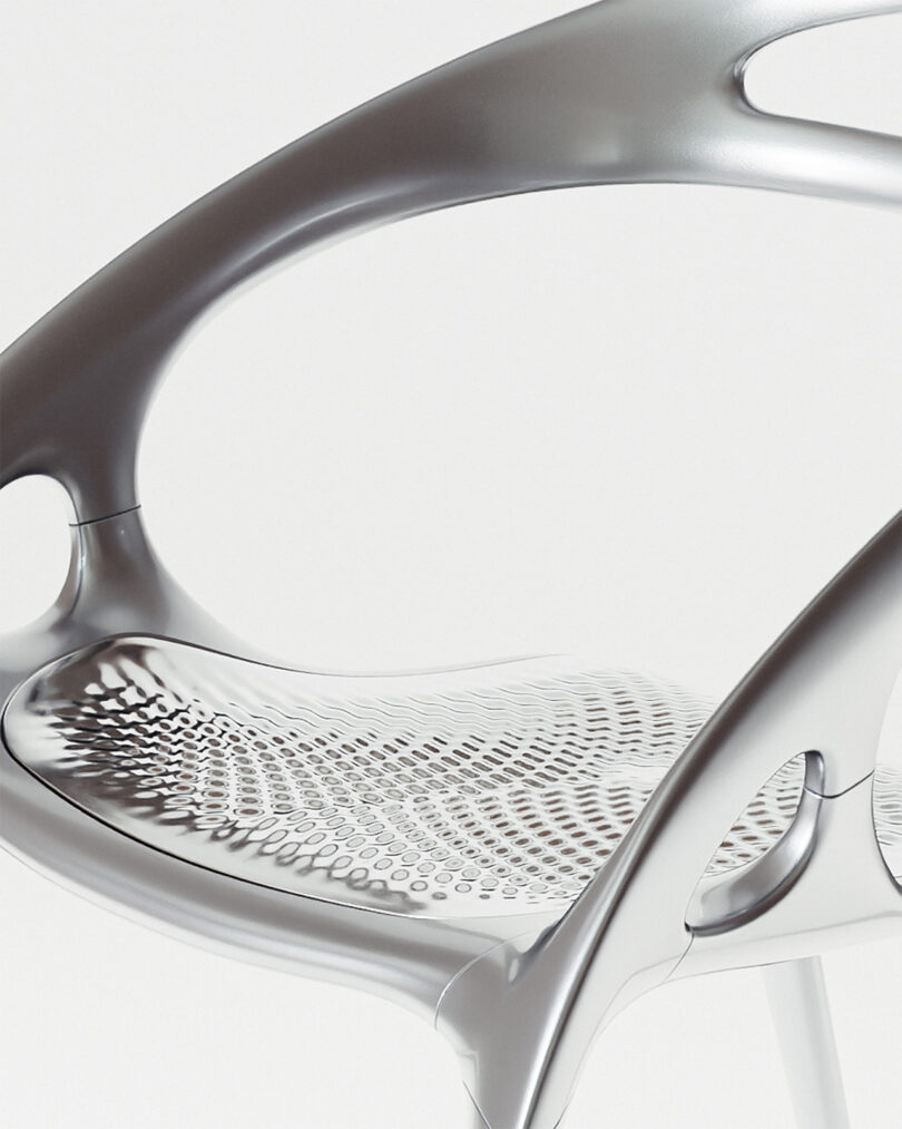 Futuristic-style silver chair with a sleek design, featuring curved armrests and a perforated seat pattern.