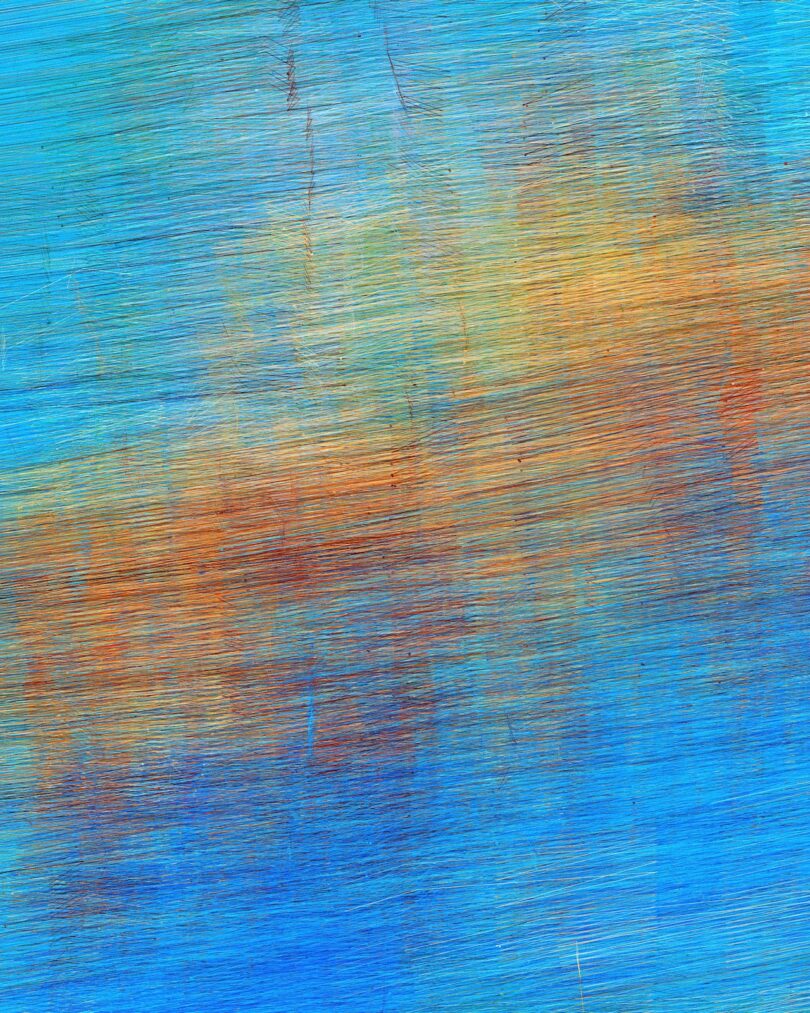 Abstract painting with blue, orange, and yellow brushstrokes blending across a textured surface