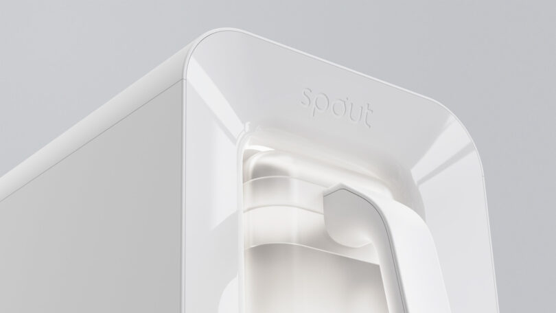 Close-up of a sleek, white water dispenser labeled "Spout," showcasing its minimalist design against a light gray background.