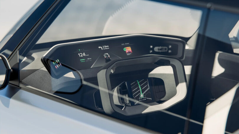 Close-up view through a car window showing a futuristic dashboard with a digital display and a modern, angular steering wheel.