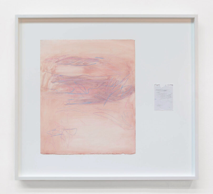 Pink drawing over torn notepad paper in single frame