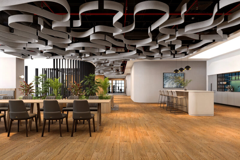Open-plan office space featuring wave-like acoustic ceiling baffles, wood flooring, and modern seating areas with greenery.