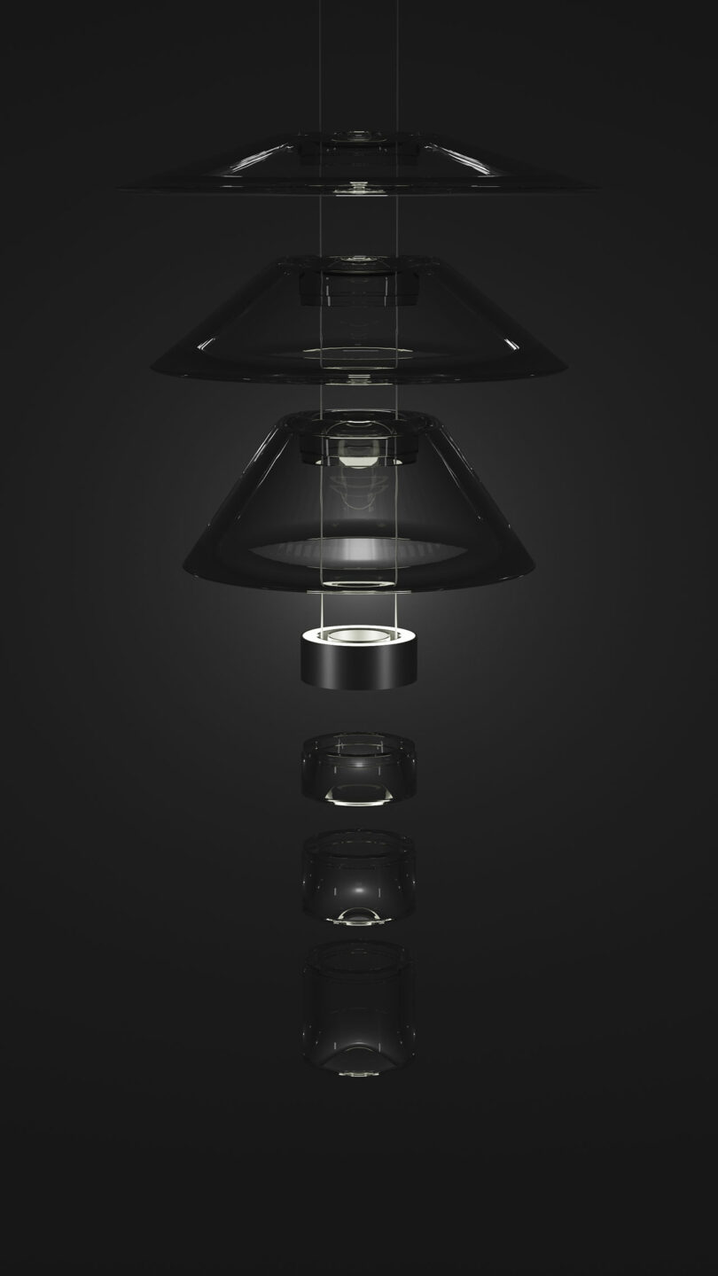 A modern Aura Snøhetta pendant light fixture with multiple transparent, layered, circular glass shades suspended vertically against a dark background.