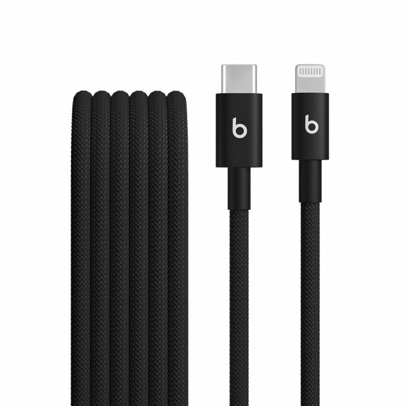 A black braided charging cable with a USB-C connector on one end and a Lightning connector on the other, both showcasing the iconic Beats logo for a stylish and reliable connection.