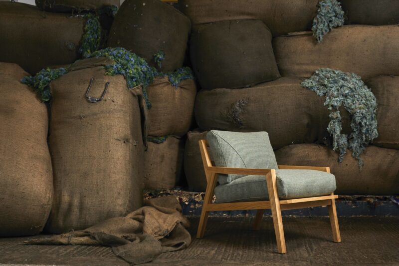 Camira Fabrics' ReSKU chair is highlighted against a backdrop of large rocks.