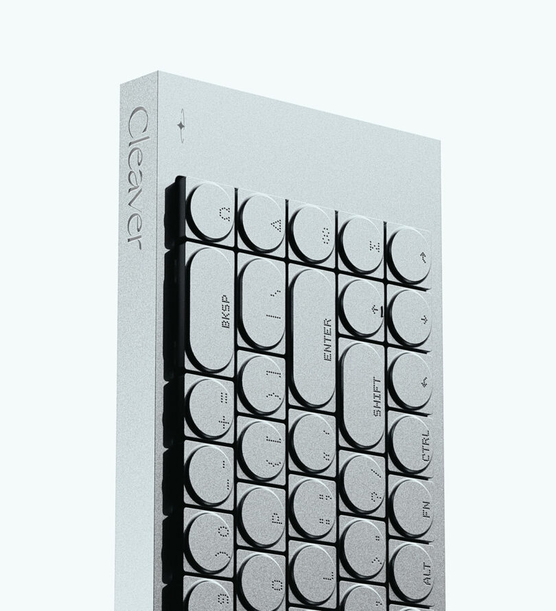 A minimalist keyboard with round keys and braille labels, featuring BKSP, ENTER, SHIFT, ALT, FN, and the word "Cleaver" engraved on the side.