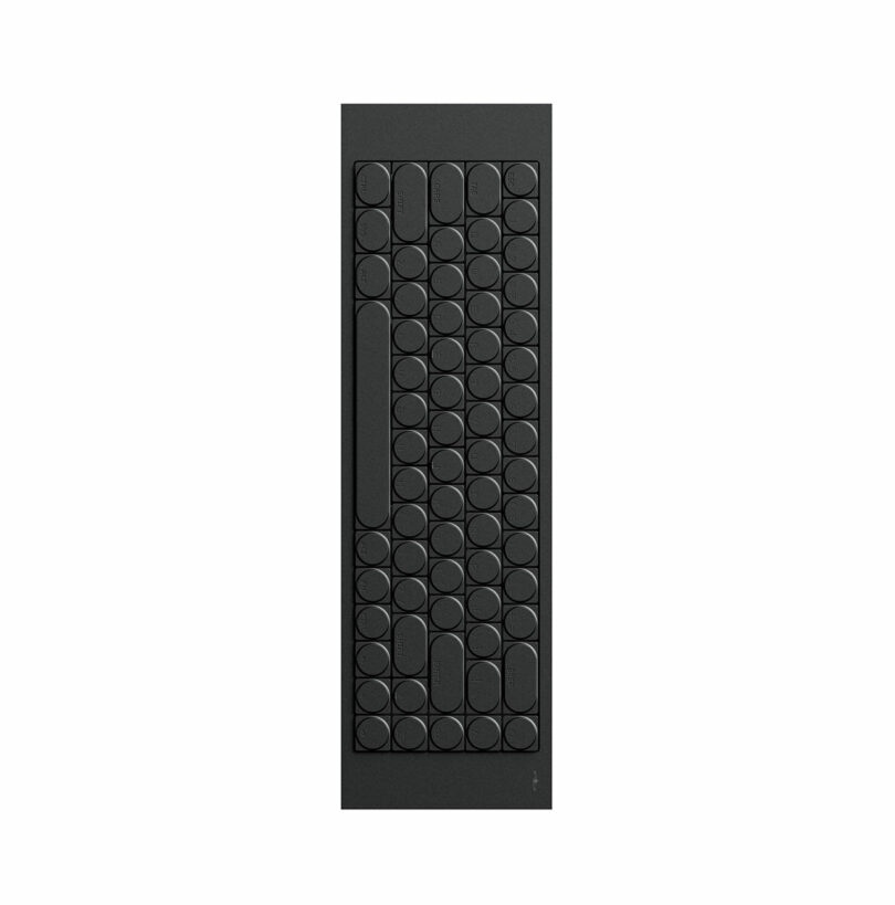 A minimalist black cleaver-inspired keyboard with rounded keys arranged in a grid pattern, photographed from above on a white background.