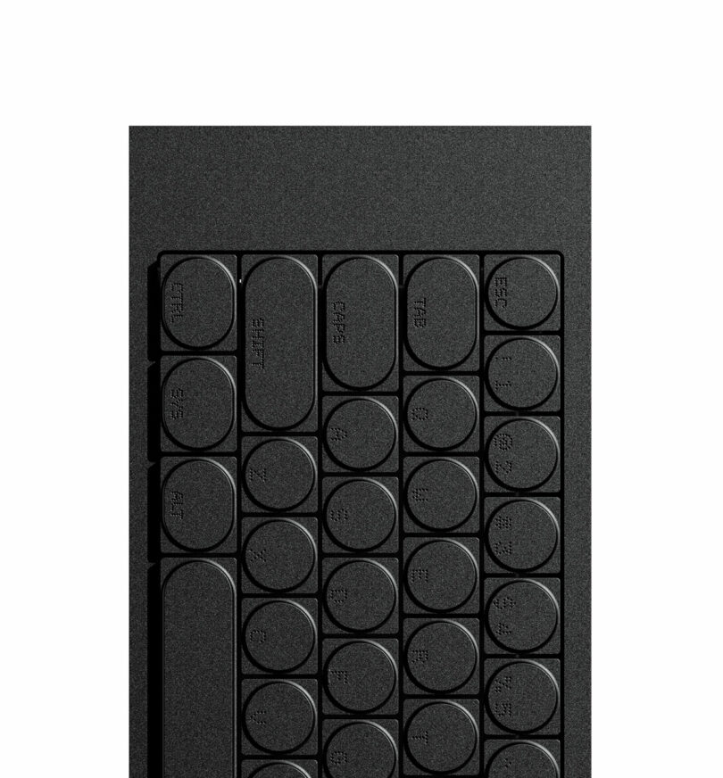 Close-up of the upper-left corner of a black keyboard with rounded keys—ESC, TAB, and SHIFT—set against a white background, resembling the precision and clean lines of a cleaver.