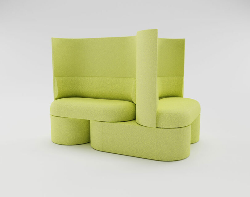 A modern modular sofa with light green upholstery, featuring curved seats and high backrests arranged in an intersecting design.
