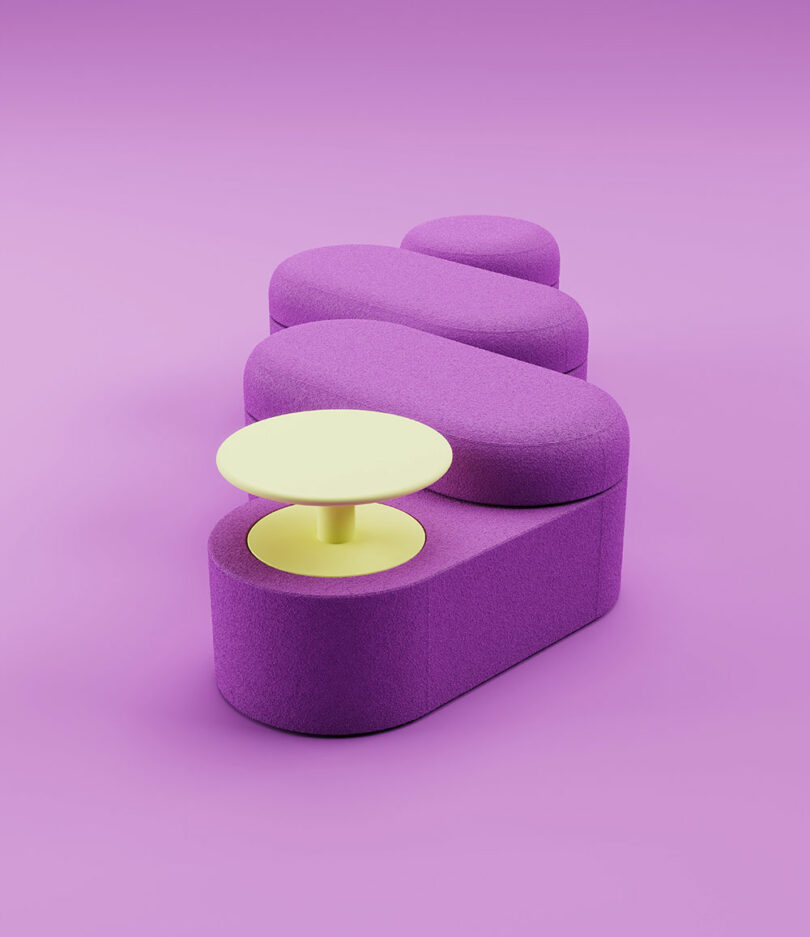 A modular purple bench with rounded shapes and a small round yellow table on one end, set against a matching purple background.