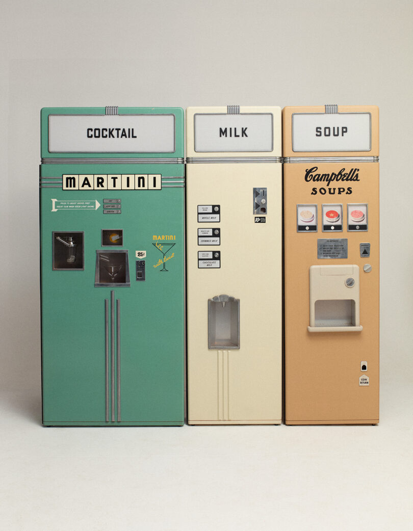 Three vintage vending machines labeled cocktail, milk, and soup stand side by side against a plain background. The soup machine displays a Campbell's logo.