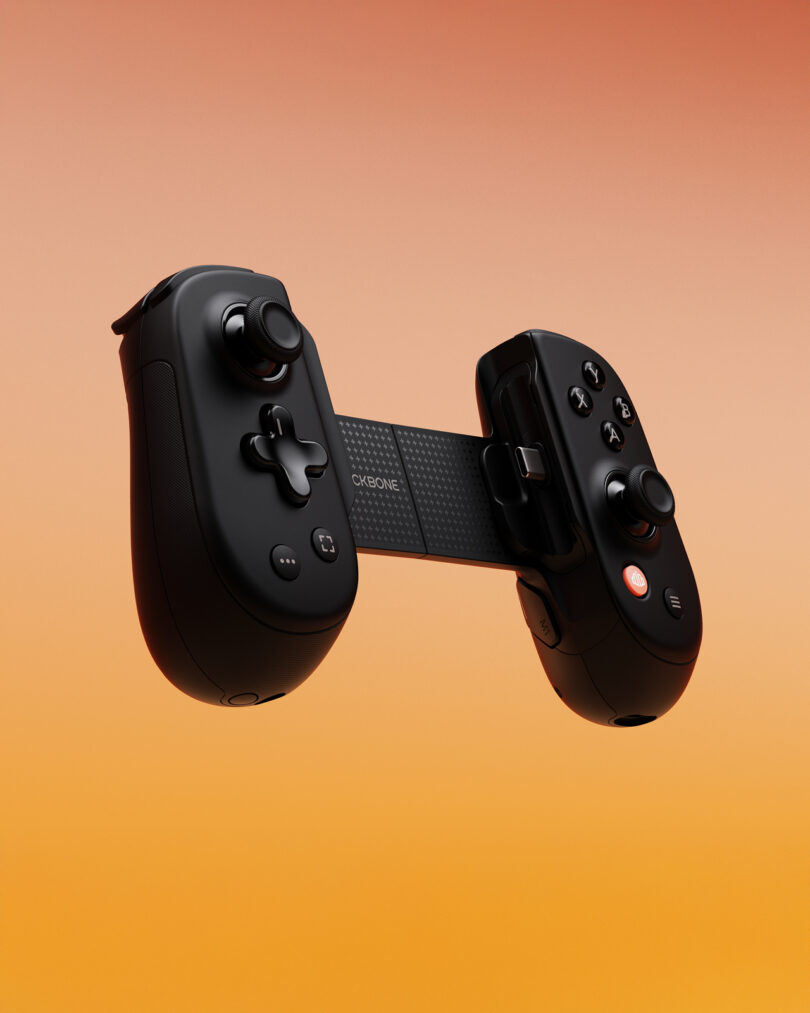 A black handheld game controller with two joysticks and multiple buttons is shown against an orange gradient background.